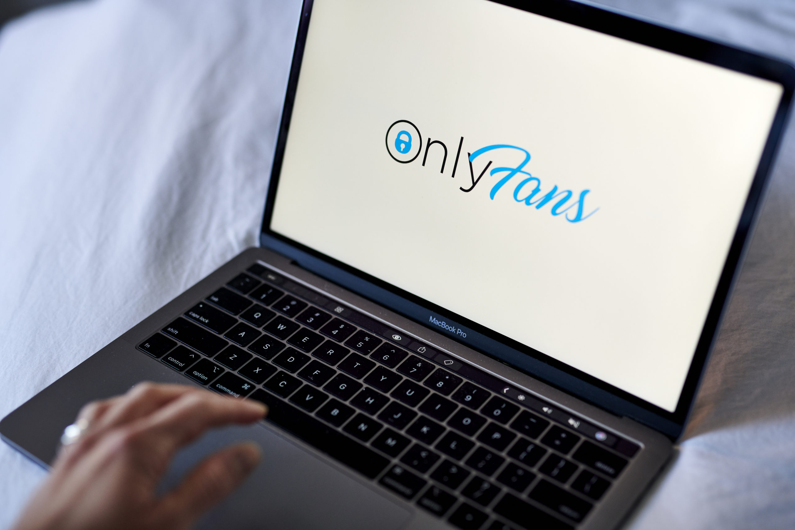 The OnlyFans logo on a laptop computer.