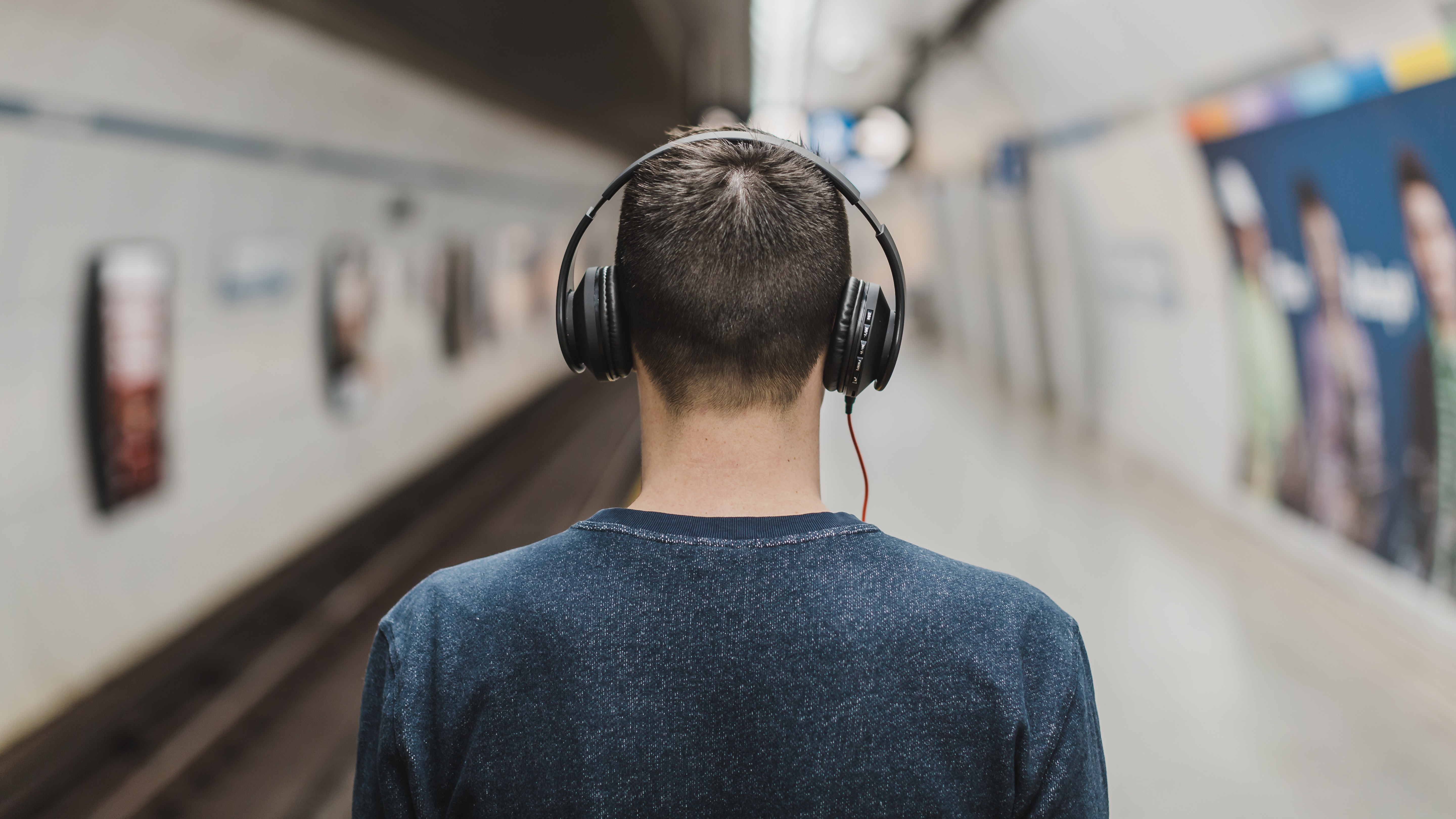 Back of man's head listening to headphones