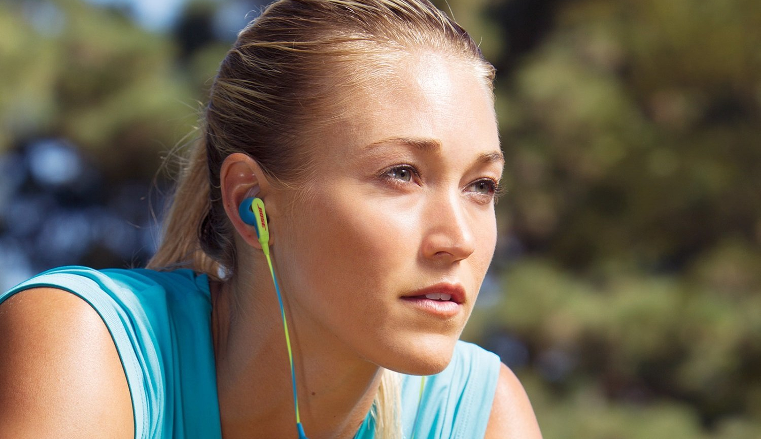 Person wearing Bose earbuds.