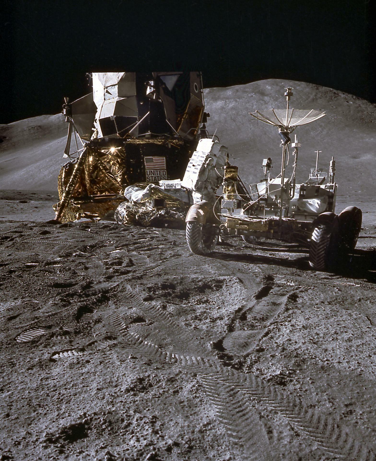 Astronaut footprints and tracks from the LRV are visible on the dusty surface of the moon, pictured here during Apollo 15.