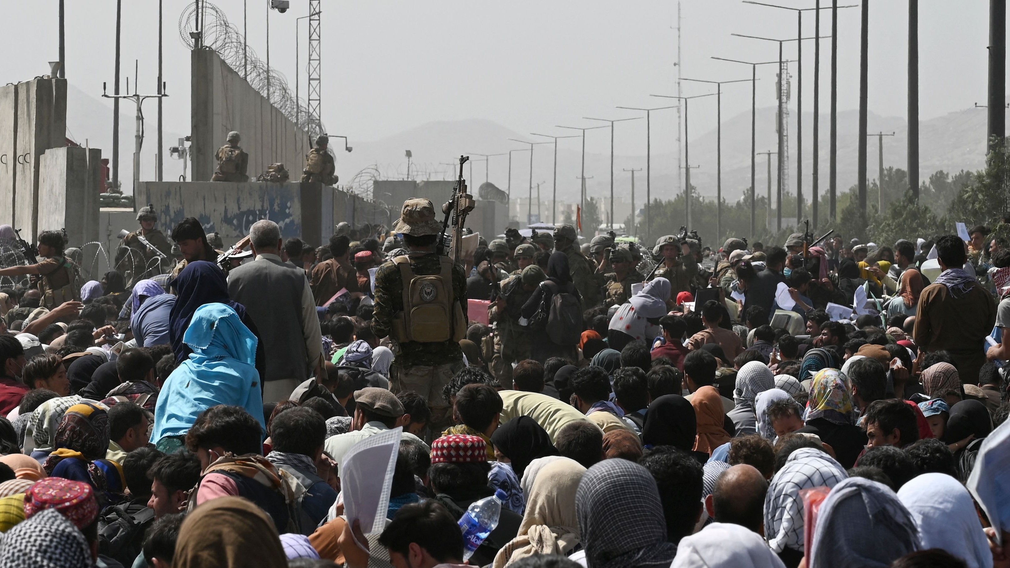 Afghans gather near the Kabul airport, hoping to flee the country. GoFundMe campaigns offer a way to help Afghans in crisis.