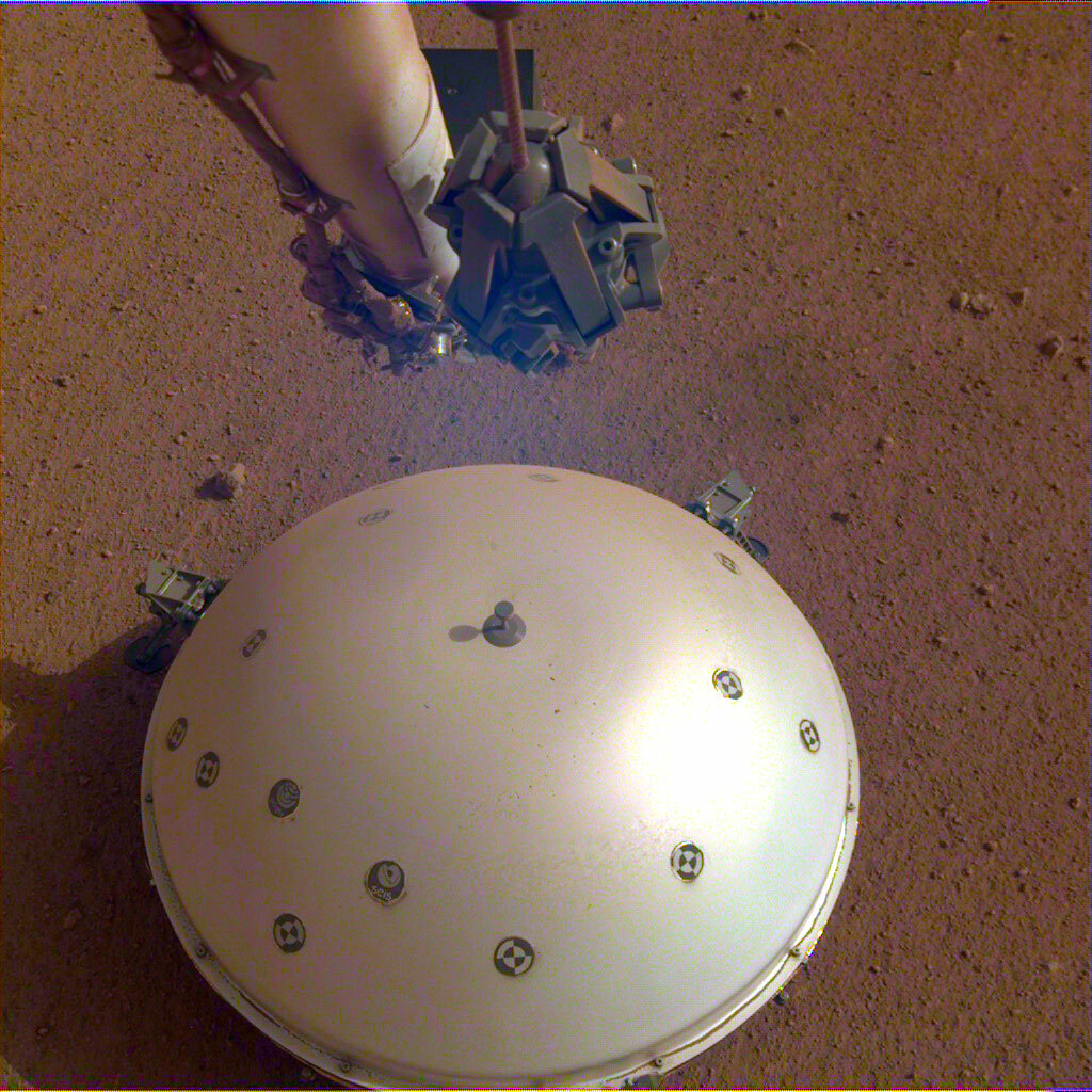 The InSight lander's seismometer is covered by a protective dome.