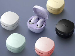 earbuds in their charging cases in colors white, purple, yellow, black, green, and pink