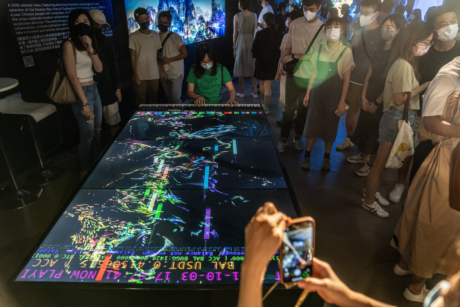 Visitors look at an art installation titled "Blockchain Piano" by Henry Chu.