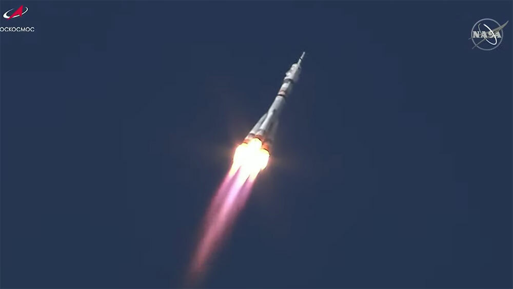 A shot of the Russian Soyuz spacecraft blasting up through the sky.