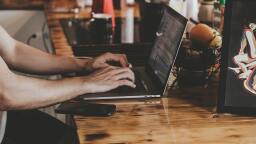 Man working on laptop in coffee shop