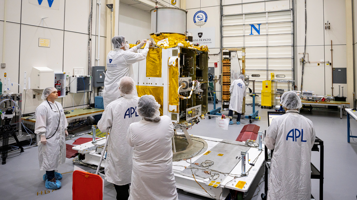 engineers working on the DART spacecraft