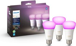 three bulbs with pink lighting next to philips hue box