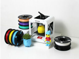 3D printer surrounded by 3D-printed toys