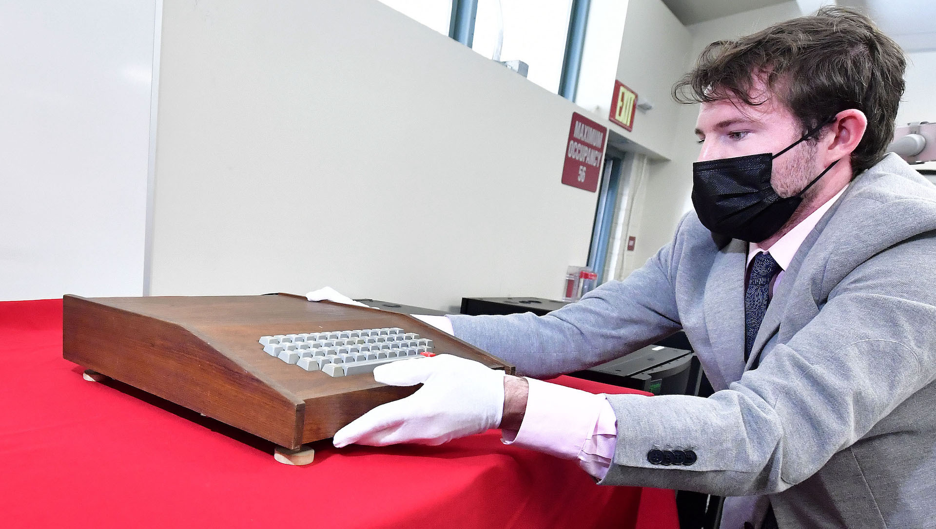 The original Apple-1 computer is removed from a box by Ian Anderson with John Moran Auctioneers.