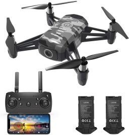 camo drone with four propellers next to remote control and two batteries