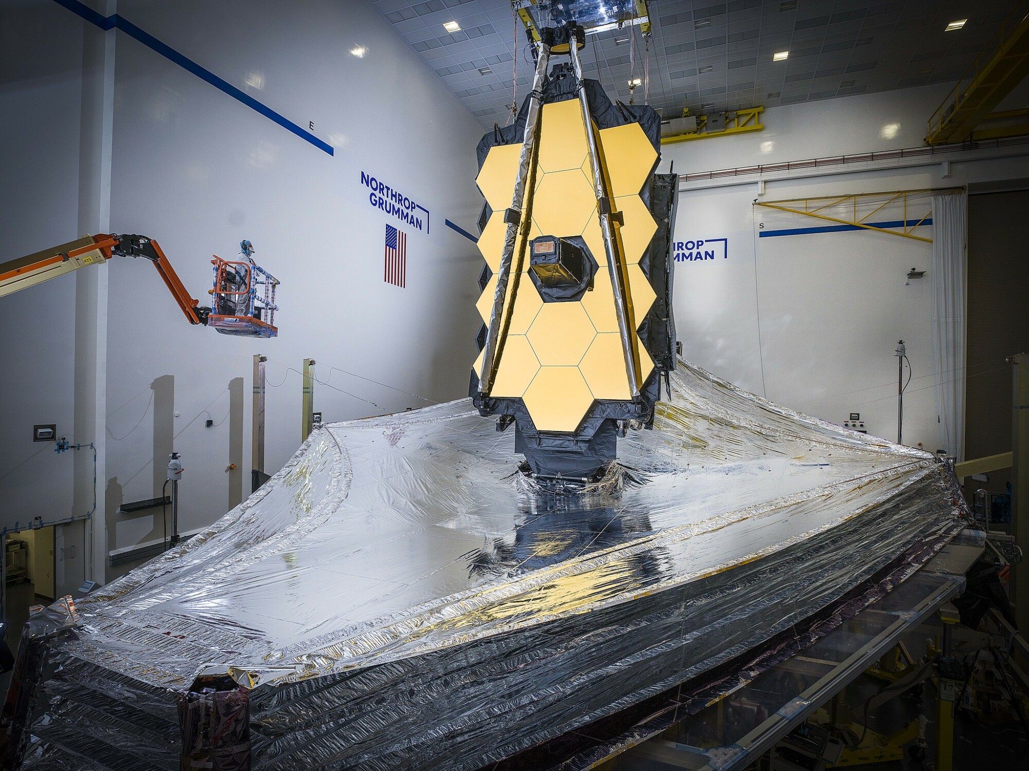 an engineer looking at the James Webb Space Telescope