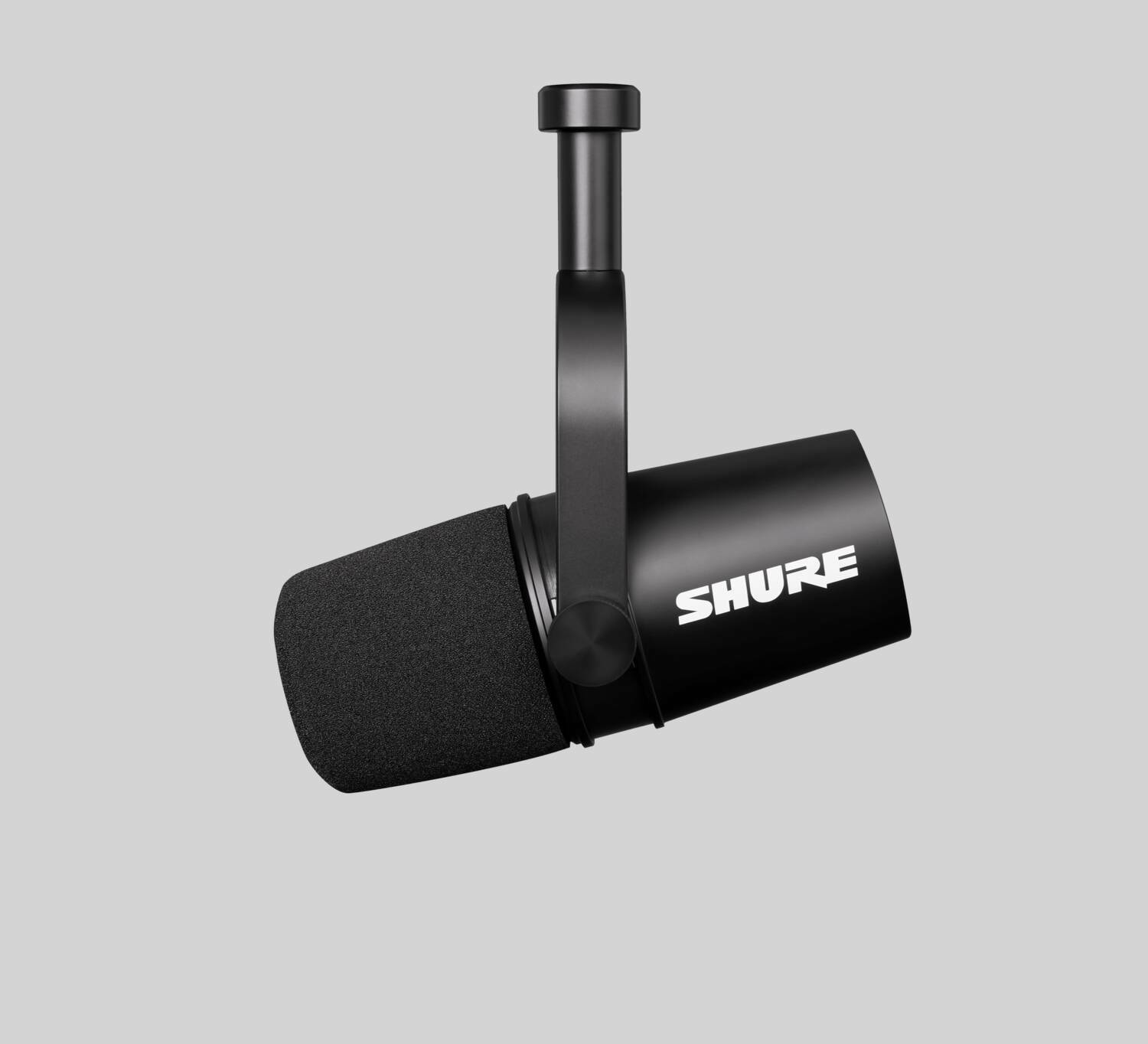 The Shure MV7 microphone against a gray background.