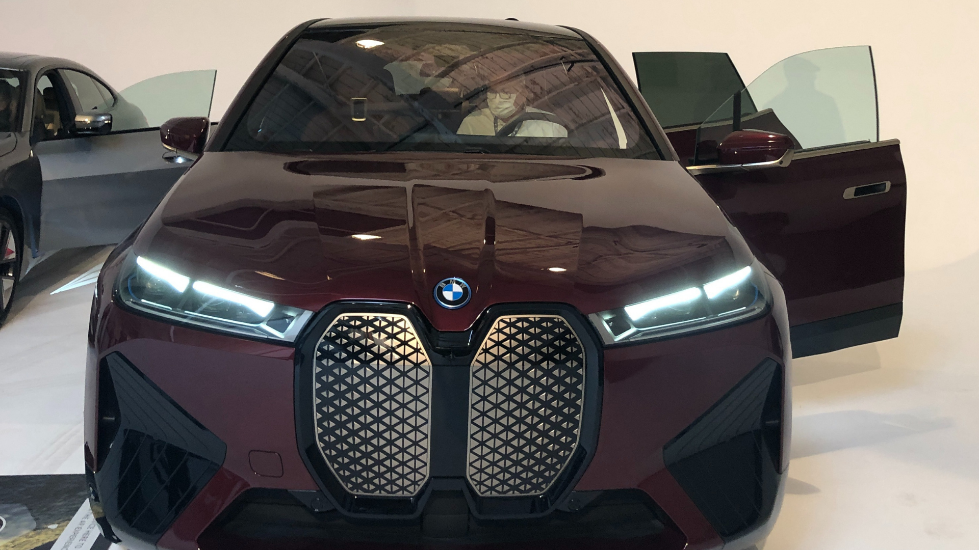 Red car with grille facing front.