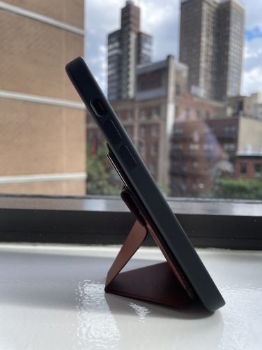 The same phone wallet as above, with the outer part detached and formed into a phone stand.