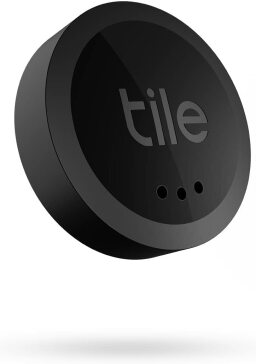 A small, black, round bluetooth tracker