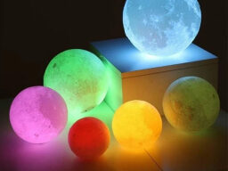 Multicolored moon-shaped glowing orbs