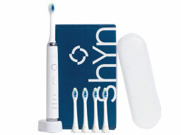 White electric toothbrush with four heads and a case next to a blue box