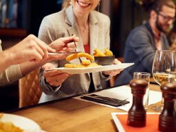 People sharing food at table