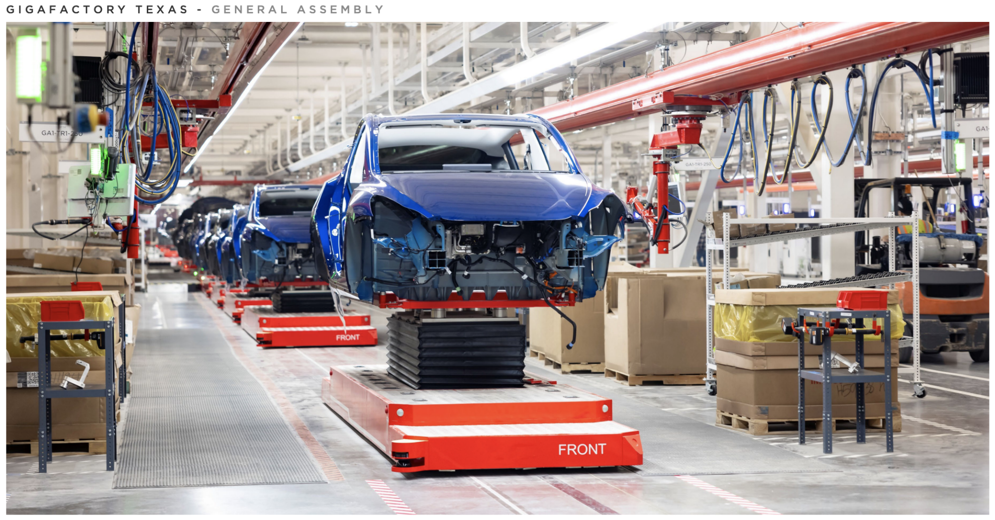 Tesla Model Y bodies on the factory floor getting assembled.