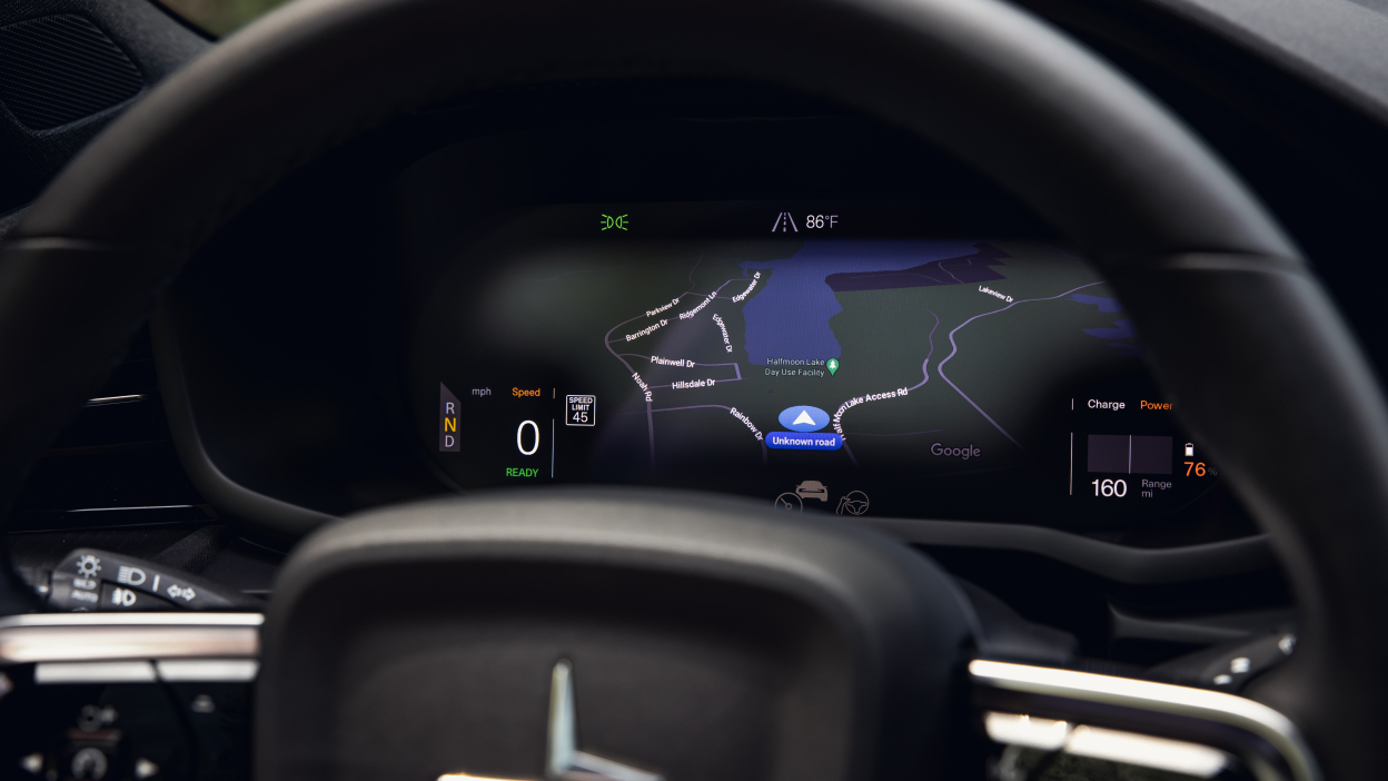 Looking at the screen with a map behind the driver's steering wheel.