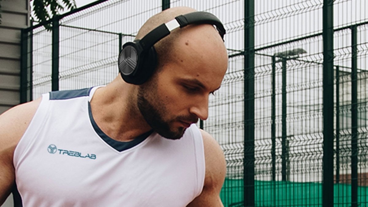 Person wearing black headphones and looking down