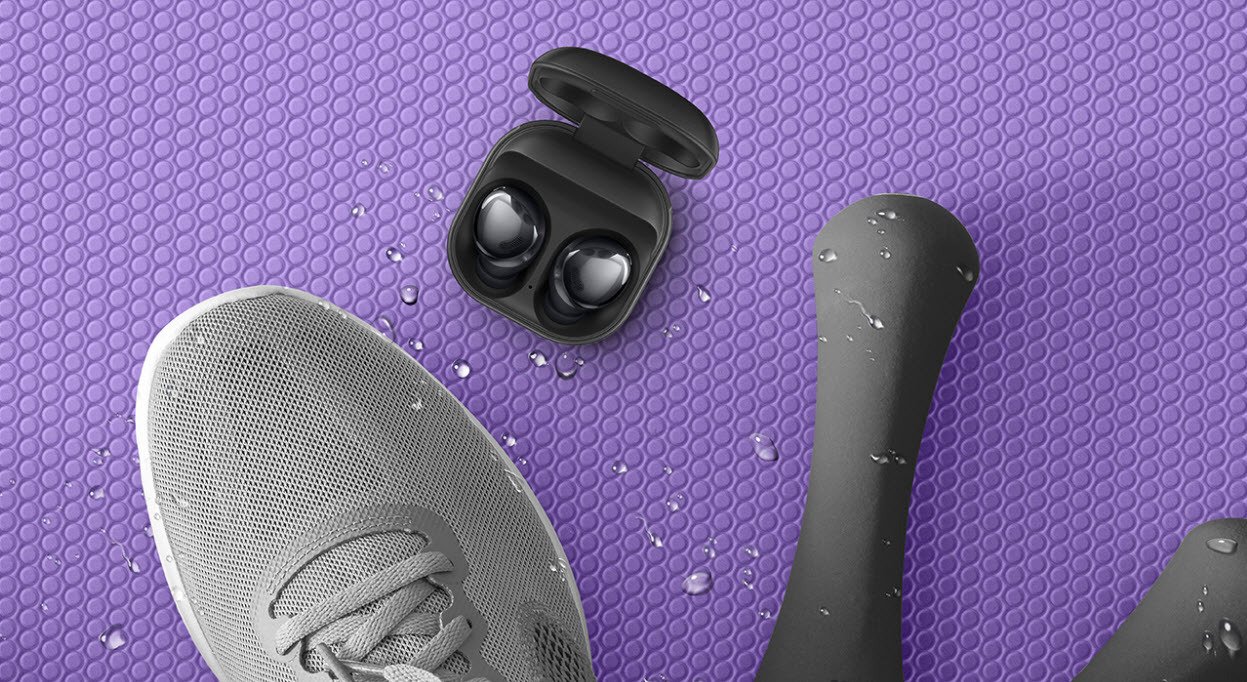 Samsung Galaxy Buds Pro headphnes in case next to running shoes and weights