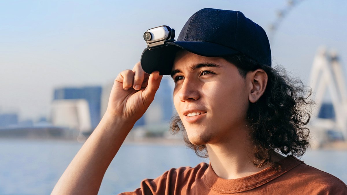 Person with small camera attached to hat, looking into distance