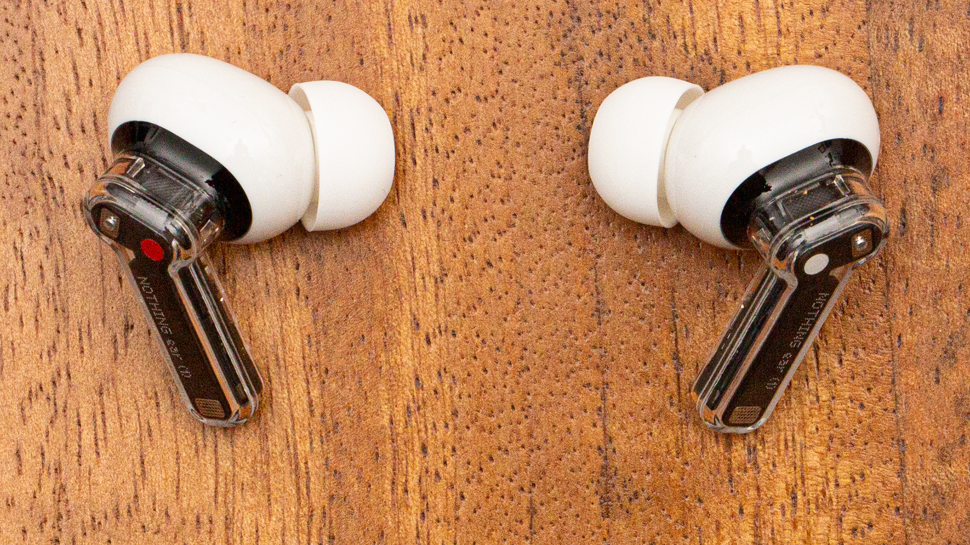 A pair of Nothing Ear (1) semi-transparent earbuds.