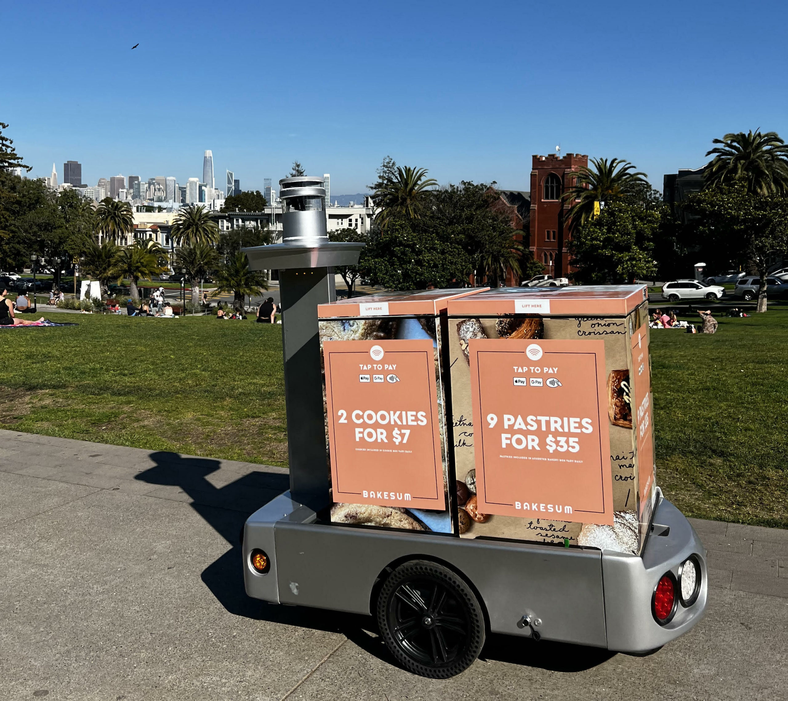 A mobile vending machine with one big wheel selling pastries in front of Dolores Park in San Francisco.
