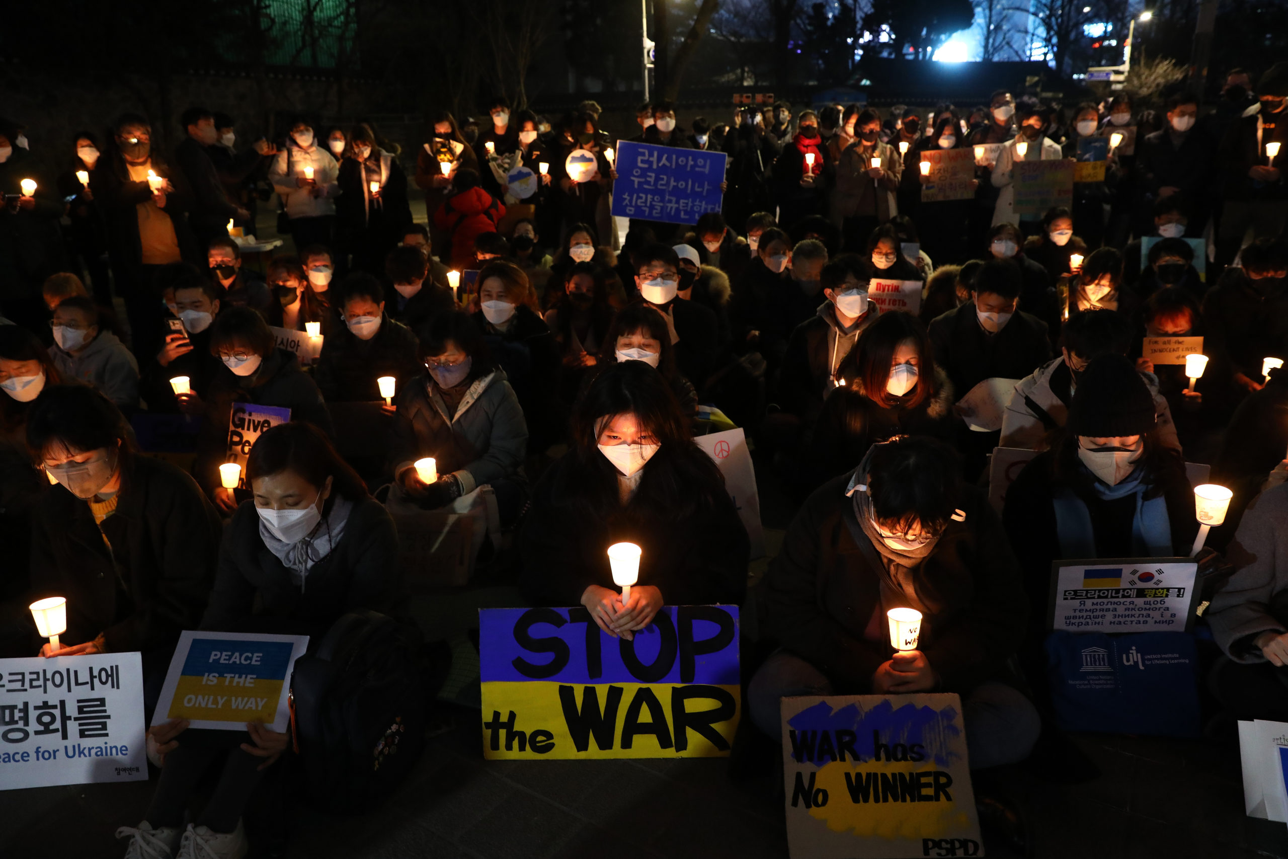 Protesters hold a candlelight vigil for the war in Ukraine.