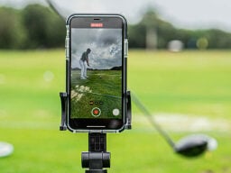 Phone recording person playing golf