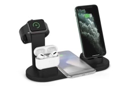 Black charging stand with airpods, two phones, and an apple watch