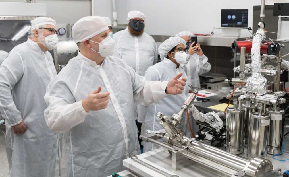 scientists collecting lunar gases from a moon sample