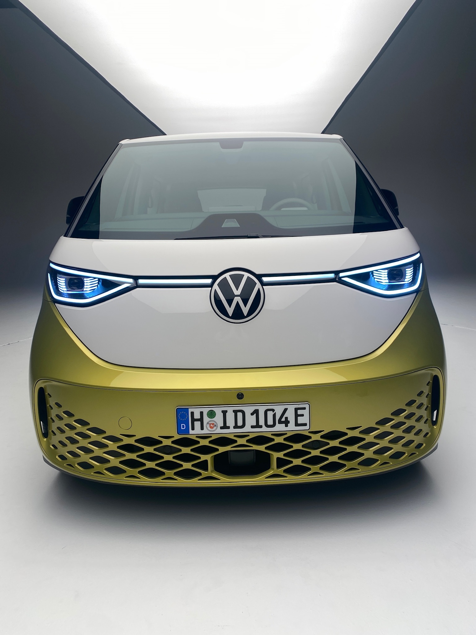 The front of the ID. Buzz shows a large front logo that makes the car look like it has a face.