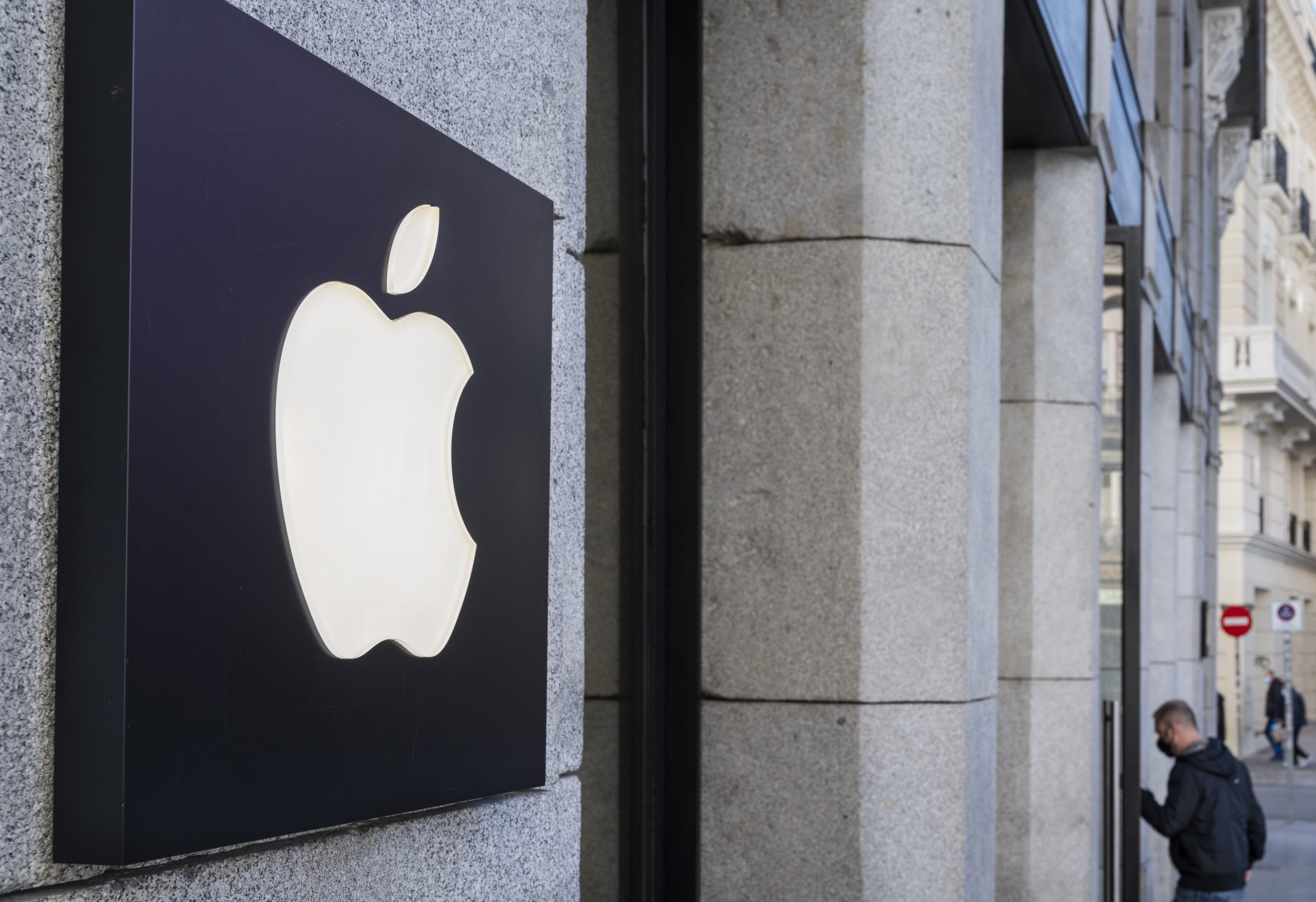 The Apple logo affixed to the side of a building.