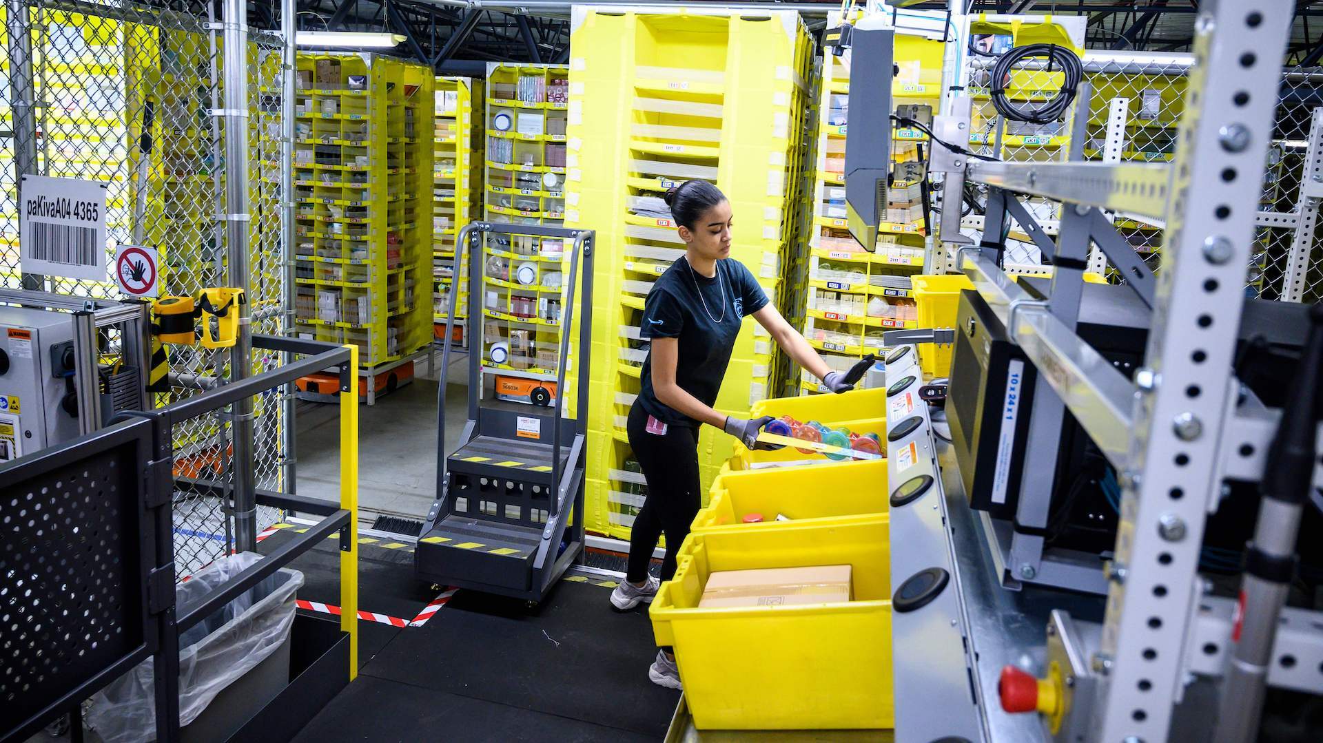 An Amazon worker works at a distribution station at the 855,000-square-foot Amazon fulfilment center in Staten Island.
