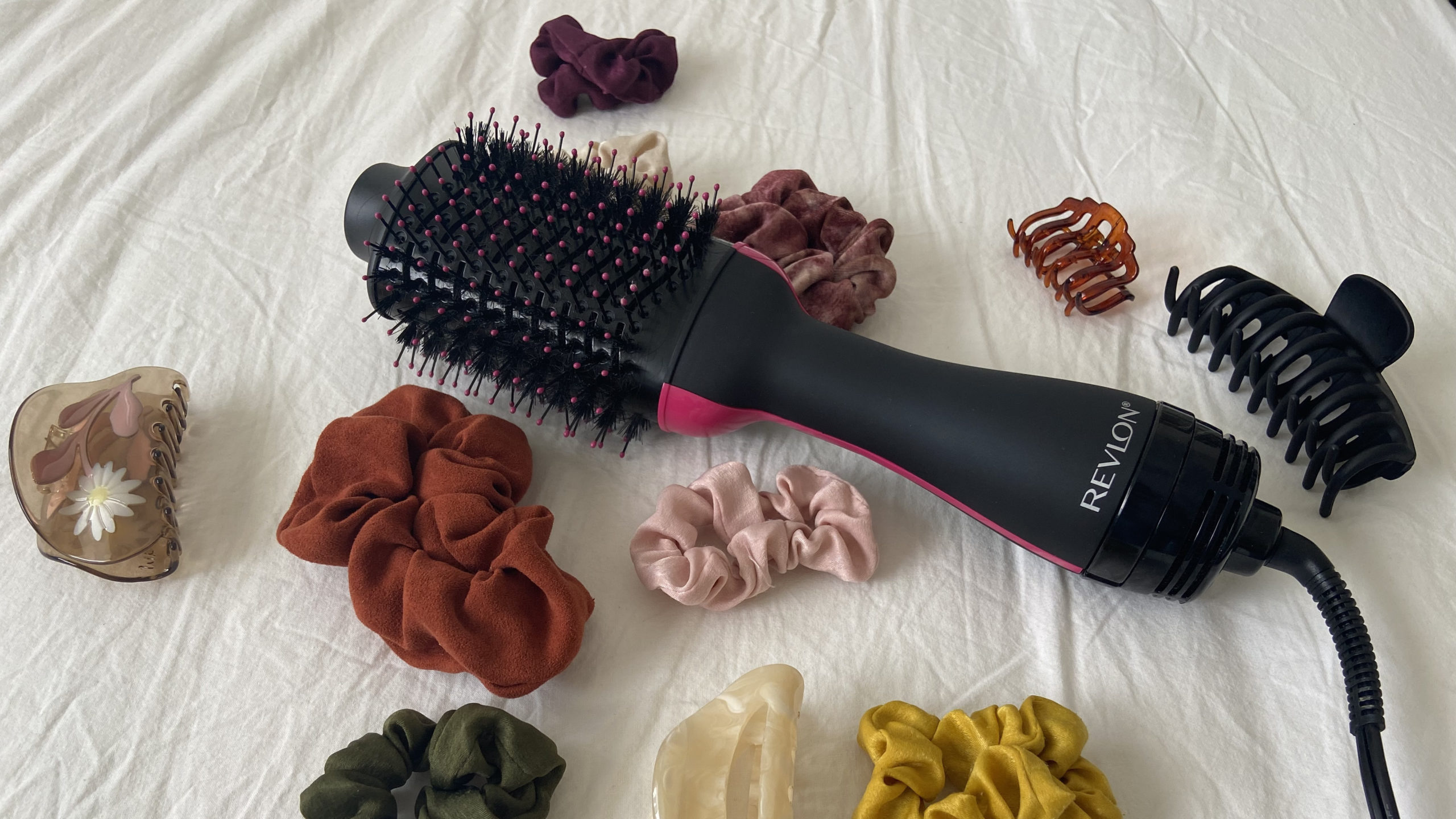 revlon one-step surrounded by scrunchies and hair clips