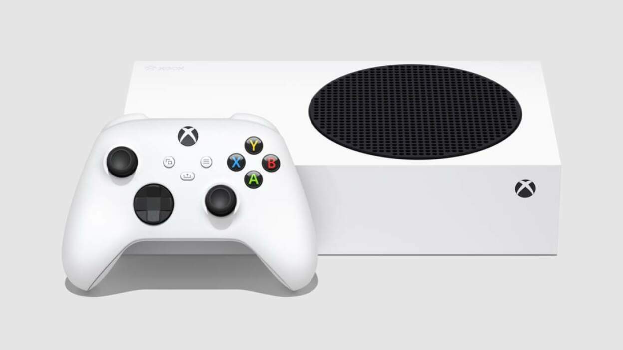 the xbox series s lying flat next to an xbox wireless controller