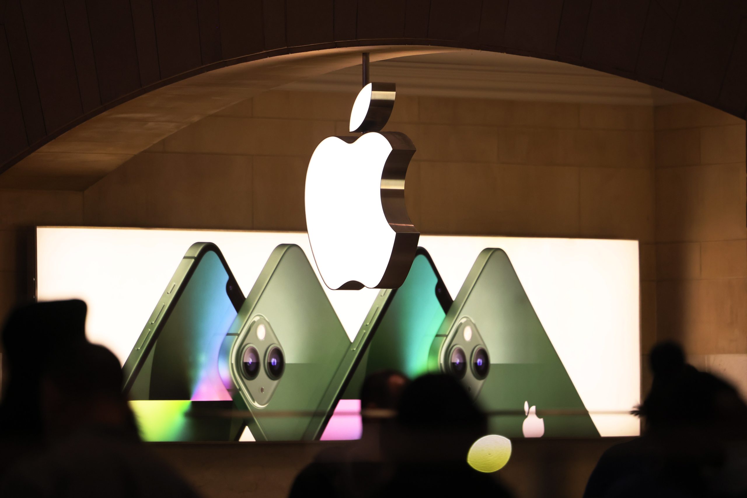 A glowing Apple logo hangs above the Grand Central Apple store, one of the first locations to pursue unionization.