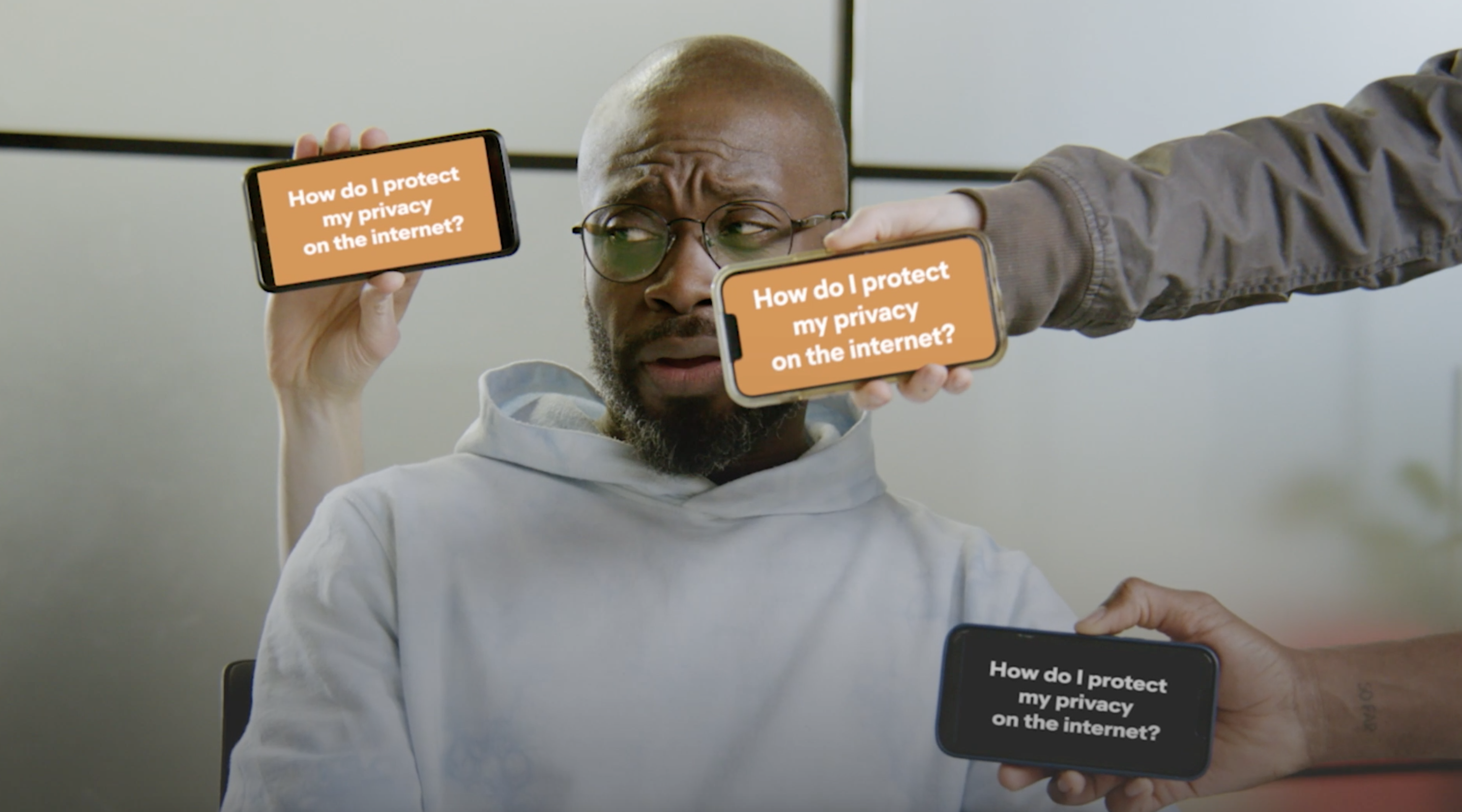 Ortis Deley sits with three cell phones around him with 