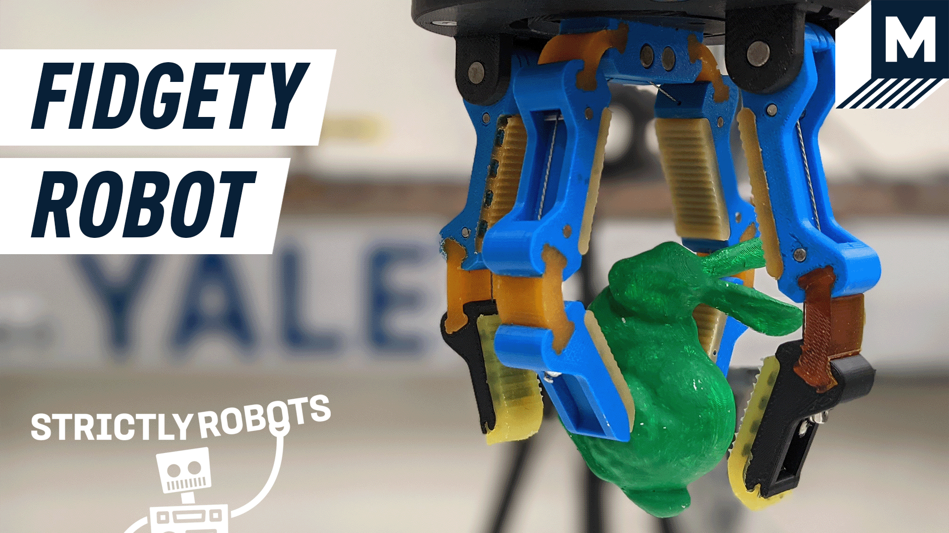 a robot hand holding a small block