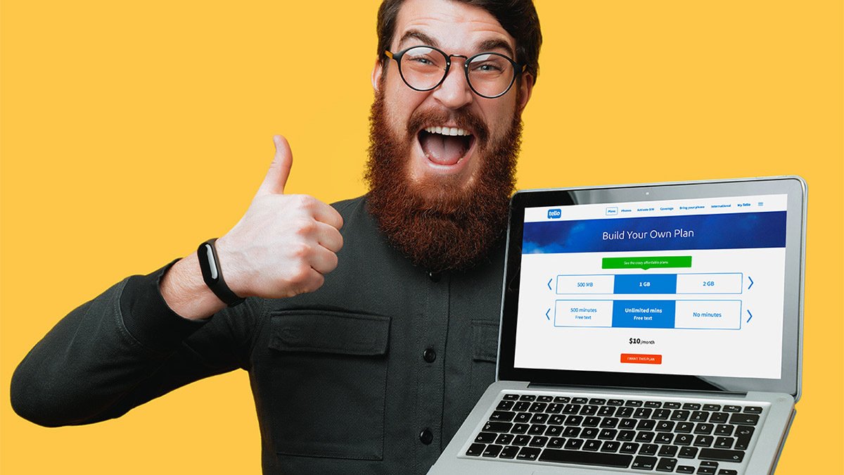 Person holding laptop showing phone plan website and making a thumbs up 