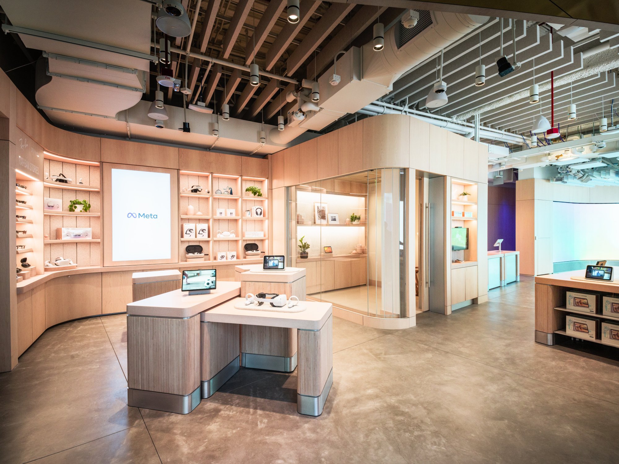 The interior of the Meta Store shows an open space with tech products.