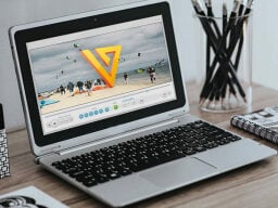 Laptop open on video of orange triangle