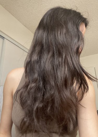 woman showing half of her head of wavy hair