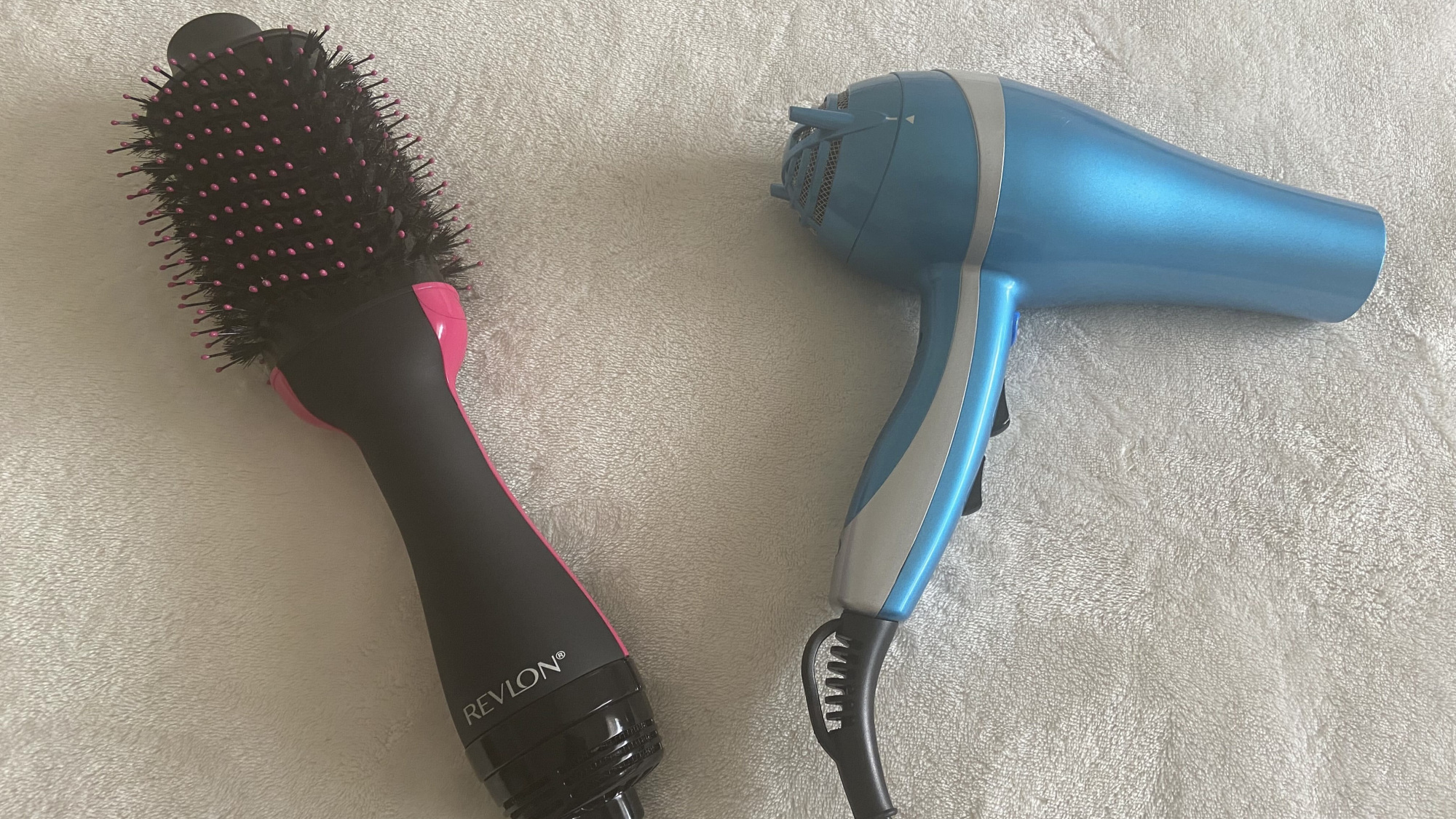 revlon one-step next to a blue blow dryer