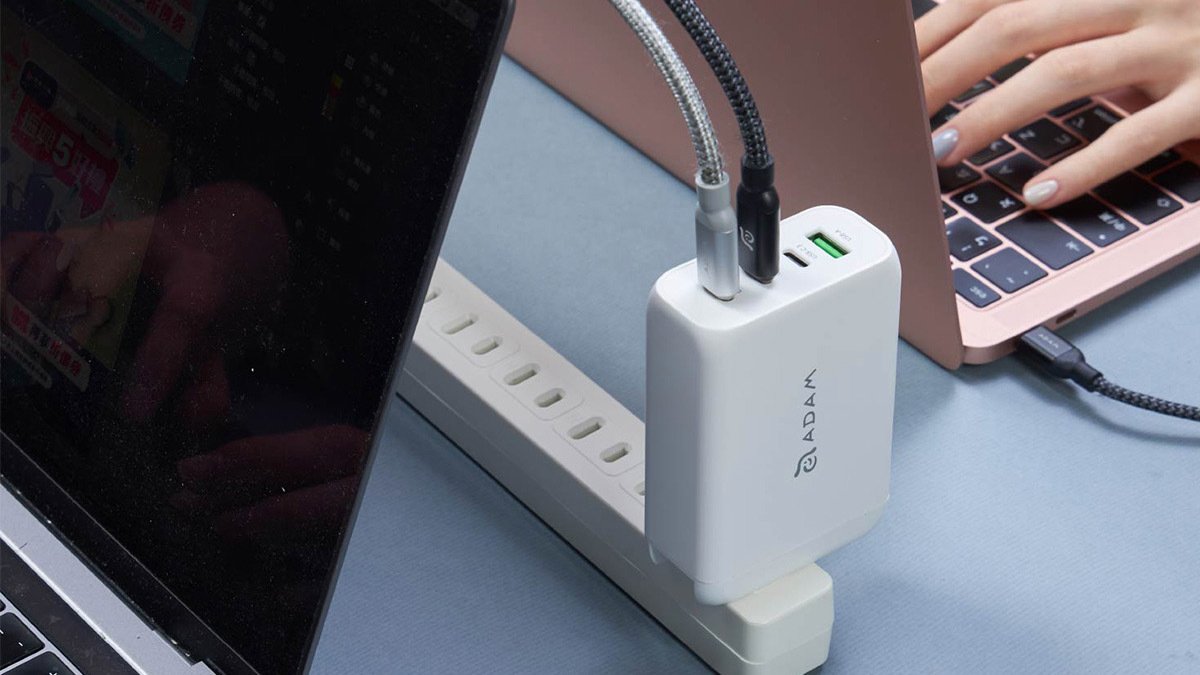 White charger plugged into strip with two USBs coming out of it
