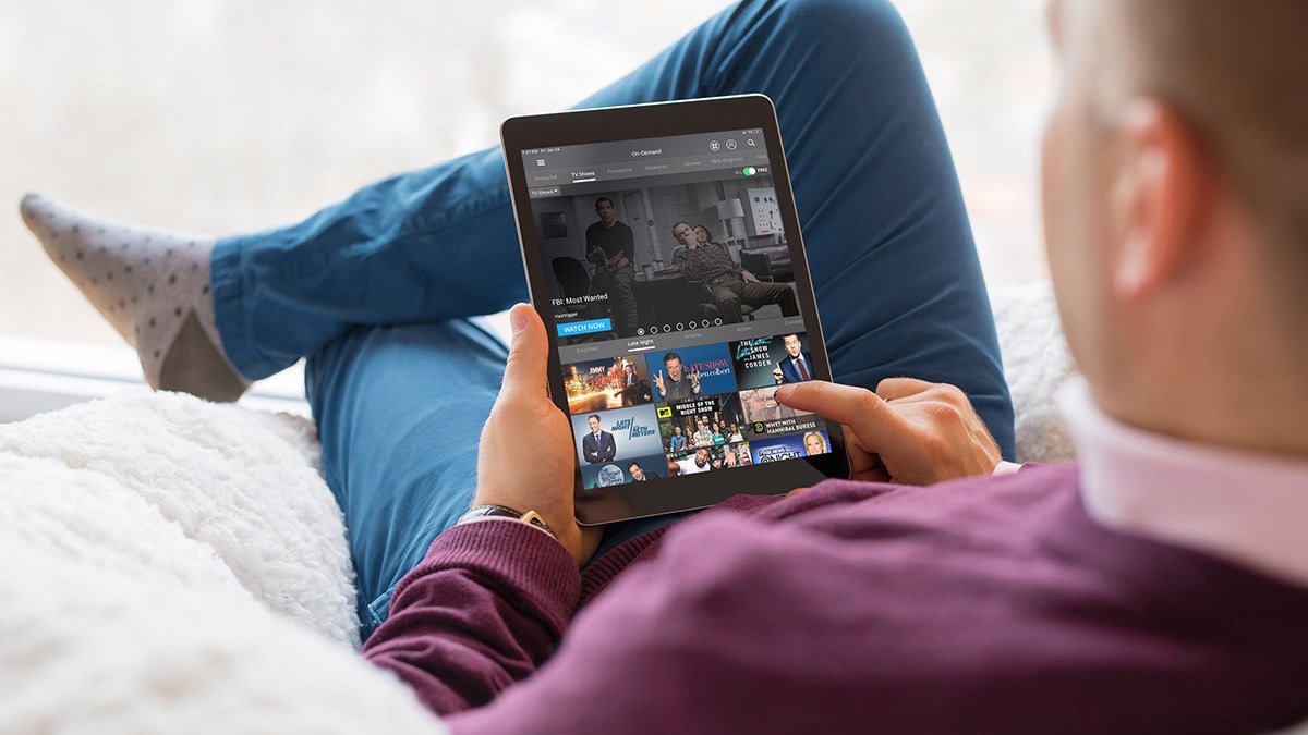 Person sitting on couch using tablet