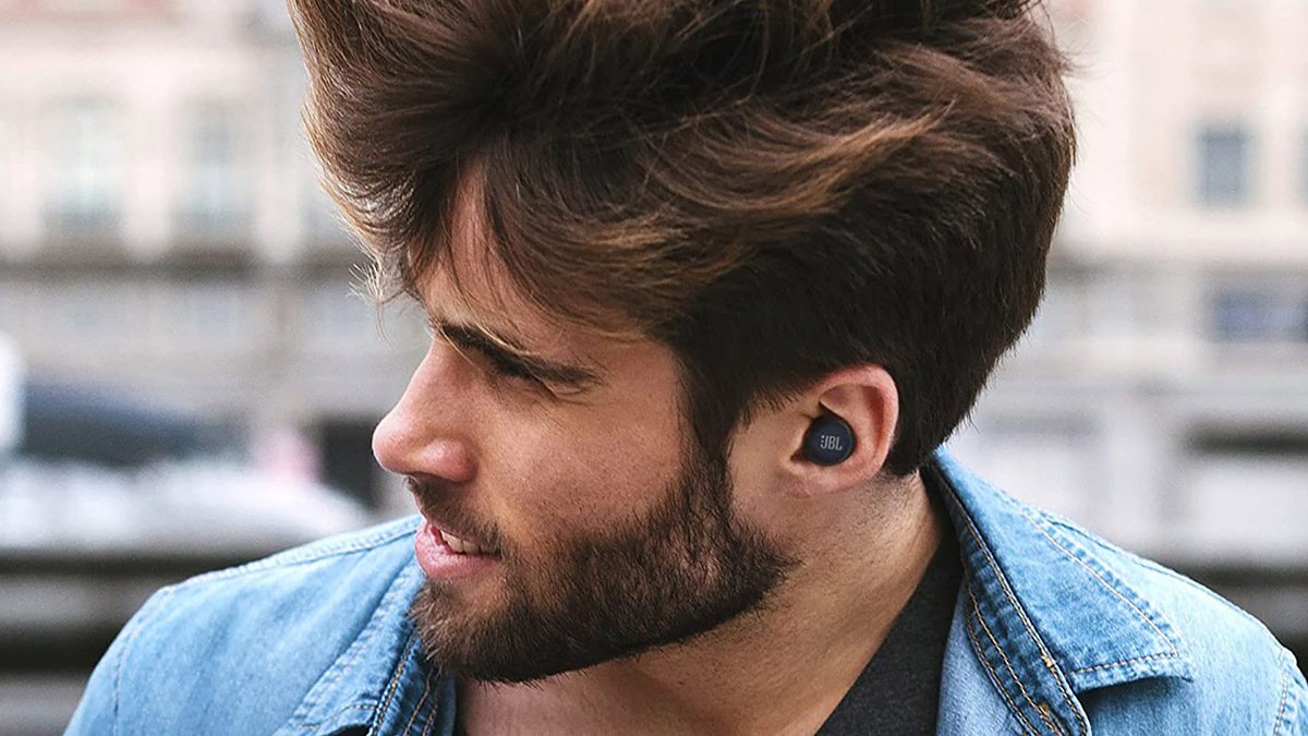 Person wearing black earbuds looking to side